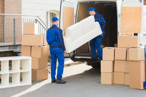 Professional man and van service handling boxes and furniture