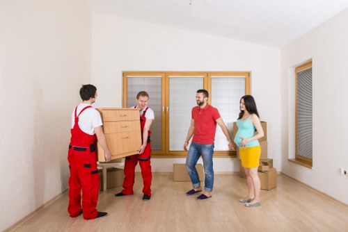 Flat removal team handling furniture in an Isleworth apartment building