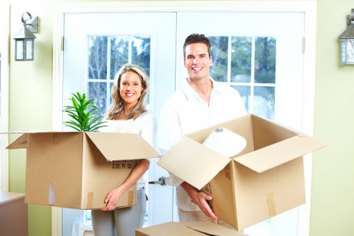 Professional movers loading household items for transport in Isleworth
